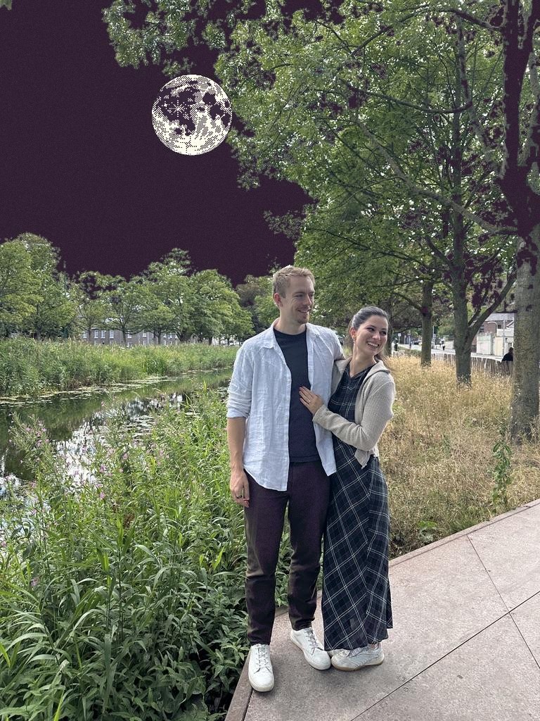 Olivia and Blaine beside the canal beneath a pixel moon