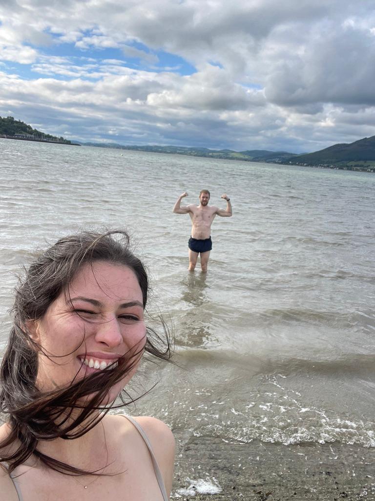 Windswept beach selfie mid-swim