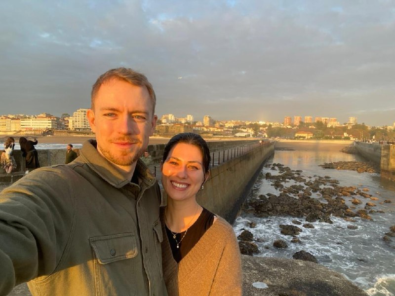Golden-hour selfie on a stone pier in Porto