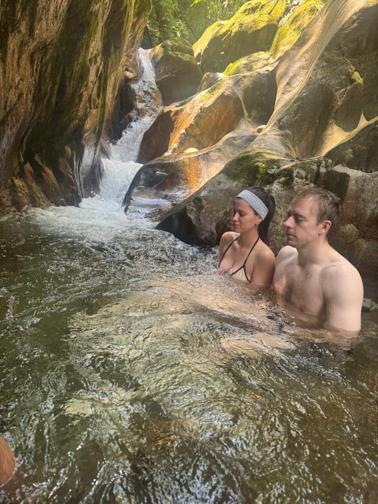 Soaking in a rocky waterfall pool